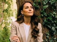 Kate Middleton leans against a tree trunk for portrait.