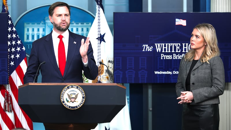 U.S. Vice President JD Vance speaks as White House Press Secretary Karoline Leavitt (R) looks on.