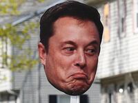 WELLESLEY, MA - APRIL 21: A spectator holds up a sign with a picture of Elon Musk's face during the 129th Boston Marathon on April 21, 2025, in Wellesley, MA. (Photo by Erica Denhoff/Icon Sportswire via Getty Images)