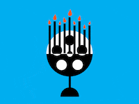 A menorah made from a film reel with candles blowing