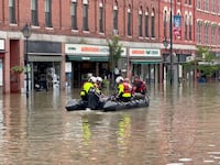 Emergency services work following flooding in Montpelier, Vermont.
