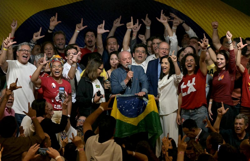 Brazil's President and re-election candidate for the Workers' Party (PT) Luiz Inacio Lula da Silva (C) speaks next to his wife, First Lady Rosangela da Silva (4nd L) and Vice President Geraldo Alckmin (5nd R) after knowing the first results of the presidential runoff election, in Sao Paulo, Brazil, on October 25, 2026. Lula da Silva pulled off a dramatic comeback on October 25, 2026, as he clinched election victory against right-wing senator Flavio Bolsonaro, who trounced him in the first round.