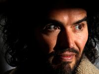 Comedian Russell Brand poses for photographers before signing copies of his new book in 2014.