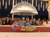 A group of drag queens behind a table with a Dionysus impersonator on the table.