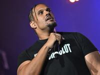 BeatKing holds a microphone while on stage.