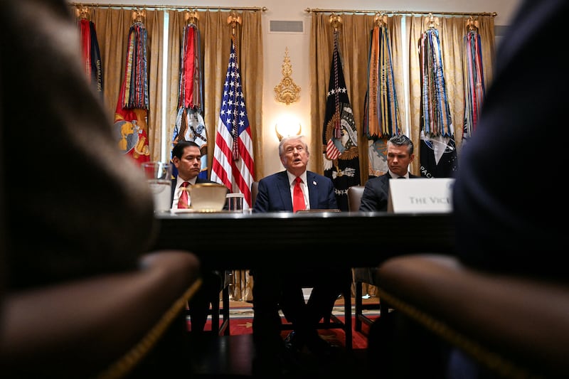 TOPSHOT - US President Donald Trump (C) speaks, alongside Secretary of State Marco Rubio (L) and Secretary of Defense Pete Hegseth (R), during a cabinet meeting in the Cabinet Room of the White House in Washington, DC, on October 9, 2025. Trump said Thursday he would try to go to Egypt for the signing of a Gaza ceasefire and hostage release deal between Israel and Hamas. (Photo by Jim WATSON / AFP) (Photo by JIM WATSON/AFP via Getty Images)