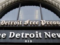 The Detroit News and Detroit Free Press signs are seen above the entrance to the newspapers building in Detroit, Michigan