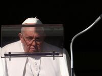 Pope Francis looks on to lead the Angelus prayer from his window