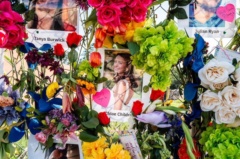 KERRVILLE, TEXAS - JULY 10: Portraits of deceased persons are displayed on a fence at a memorial on July 10, 2025 in Kerrville, Texas. Last Friday, heavy rainfall caused severe flash flooding throughout the hill country and various cities along the Guadalupe River. (Photo by Brandon Bell/Getty Images)