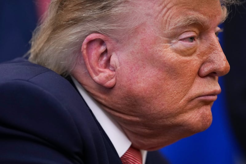 U.S. President Donald Trump looks on during an event in the Oval Office