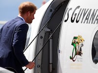 Britain's Prince Harry boards a plane