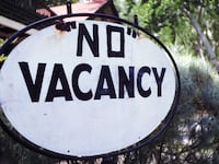 A photo including a No Vacancy sign