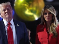Donald and Melania Trump in front of a gold balloon