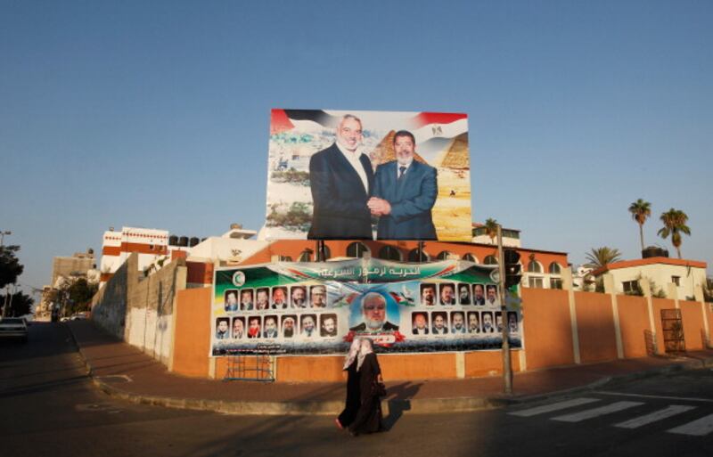 articles/2013/09/23/a-more-violent-hamas/morsi-hamas-openz_fbxak4