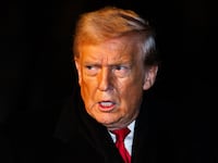 President Donald Trump walks over to reporters to make a brief statement before departing from the South Lawn of the White House in Marine One on January 20, 2026 in Washington, DC.