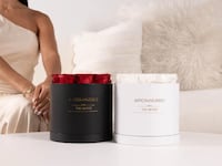 Aroma360 Monet Scent Diffusers displayed in black and white bases with preserved red and white roses, styled in a modern living room as an elegant Valentine’s Day gift and decorative home fragrance diffuser.