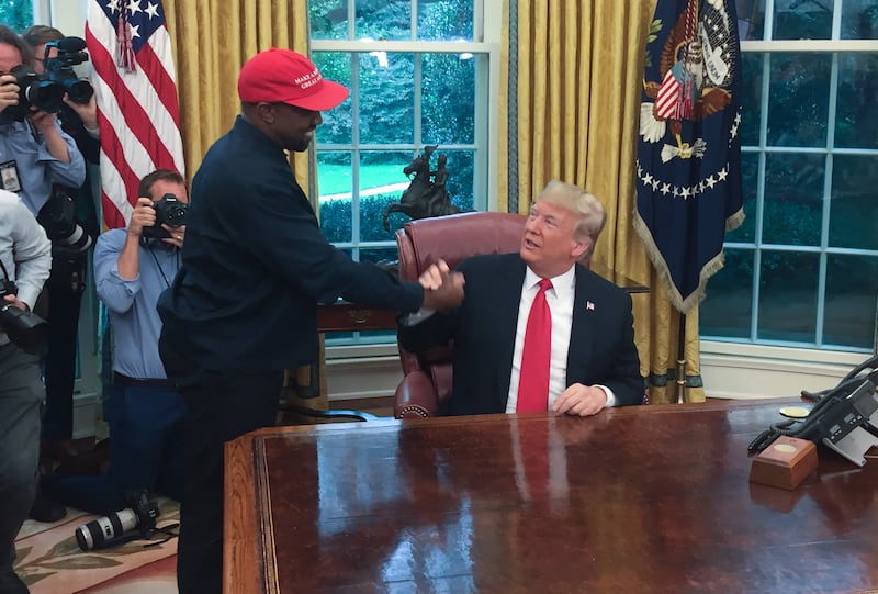 US President Donald Trump meets with rapper Kanye West in the Oval Office of the White House in Washington, DC, October 11, 2018.