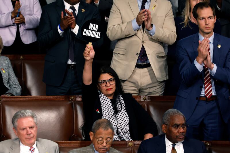 Rep. Rashida Tlaib (D-MI) holds a sign that reads "War Criminal" as Israeli Prime Minister Benjamin Netanyahu addresses a joint meeting of Congress in the chamber of the House of Representatives at the U.S. Capitol on July 24, 2024