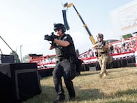 Law enforcement officers move following a shooting during a rally held by Donald Trump in Butler, Pennsylvania.