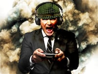 Pete Hegseth wearing a army helmet and a video game headset holding a video game controller, in front of explosions