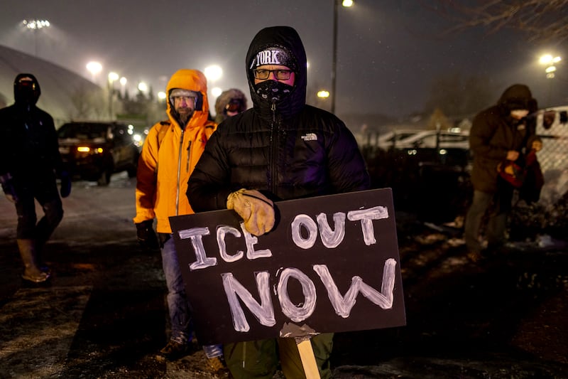 MINNEAPOLIS, MINNESOTA - JANUARY 18: A protester with an anti-ICE sign, stands outside of the Henry Bishop Whipple Federal building on January 18, 2026 in Minneapolis, Minnesota. Protesters continued to gather to demonstrate against an ongoing immigration enforcement dubbed "Operation Metro Surge". (Photo by Jim Vondruska/Getty Images)