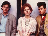 A photo still of Andrew McCarthy, Molly Ringwald, and Jon Cryer