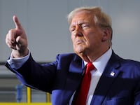 Donald Trump gestures as he makes a campaign stop at manufacturer FALK Production in Walker, Michigan.