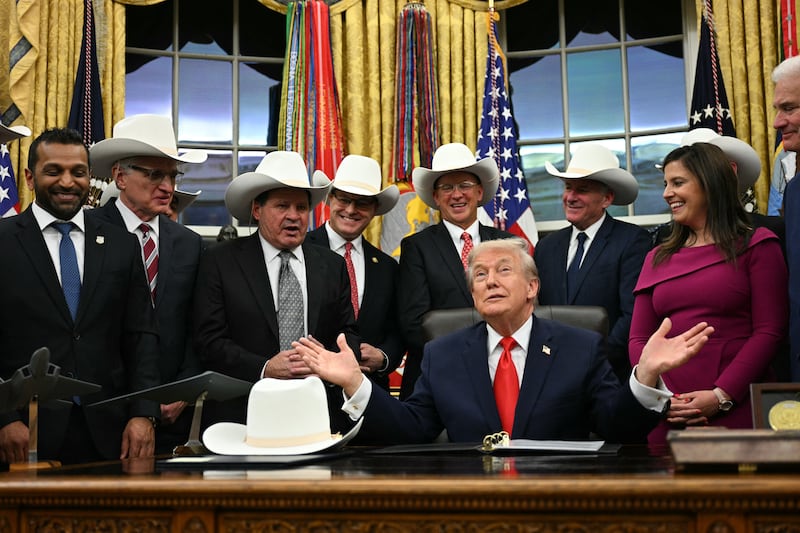 US President Donald Trump speaks during a bill signing ceremony with members of the 1980 US Olympic men's ice hockey team in the Oval Office of the White House in Washington, DC, on December 12, 2025. The legislation will award all of the players with Congressional Gold Medals to recognize the 45th anniversary of the US victory at the 1980 Winter Olympic Games. (Photo by Jim WATSON / AFP via Getty Images)