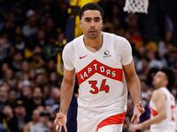 Jontay Porter celebrates on the court after making a three-point shot.