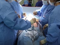 A surgeon and his theatre team perform key hole surgery