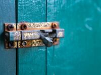 Padlock on wooden door.