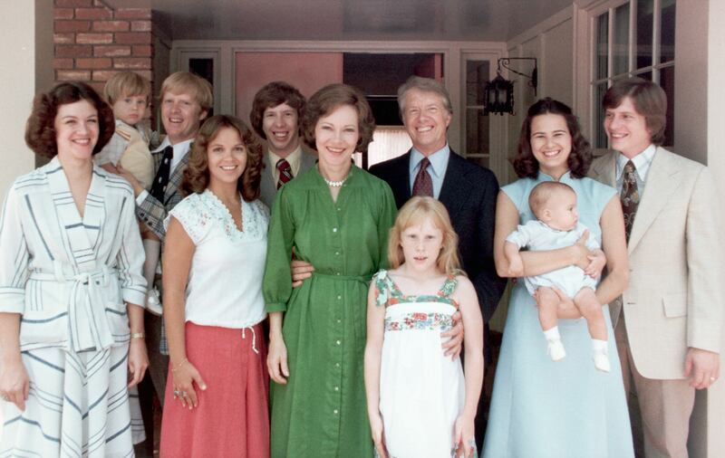 A portrait of President Jimmy Carter and his extended family. Left to right: Judy (Mrs. Jack Carter); Jason James Carter; Jack (John William Carter); Annette (Mrs. Jeff Carter); Jeff (Donnel Jeffrey Carter); First Lady Rosalynn Carter; daughter Amy Lynn Carter; President Carter; daughter-in law Caron Griffin Carter holding James Earl Carter IV; and son Chip (James Earl Carter III). 1977-1980. | Location: outdoors. (Photo by © CORBIS/Corbis via Getty Images)