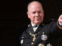 Prince Albert II points at a crowd during celebrations in Monaco.