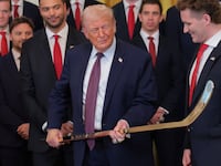 WASHINGTON, DC - JANUARY 15: Aleksander Barkov (L) and Matthew Tkachuk (R) of the Florida Panthers present U.S. President Donald Trump (C) with a jersey and hockey stick during a ceremony to honor the 2025 Stanley Cup Champion Florida Panthers in the East Room of the White House on January 15, 2026 in Washington, DC. The Florida Panthers defeated the Edmonton Oilers for the second straight year in their first-ever championships since joining the NHL in 1993. (Photo by Anna Moneymaker/Getty Images)