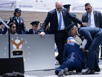 US President Joe Biden is helped up after falling during the graduation ceremony at the United States Air Force Academy