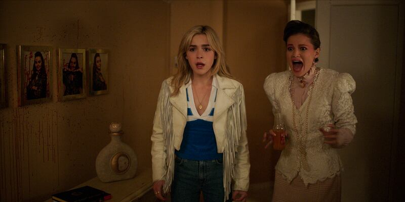 Kiernan Shipka as Jamie Hughes, Olivia Holt as Teen Pam in Totally Killer.