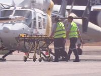Paramedics push a stretcher following U.S. military aircraft crash in Darwin, Australia, Aug. 27, 2023, in this screen grab obtained from a handout video.