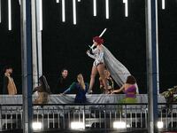 A model walking on a catwalk during the Olympics opening ceremony in Paris.
