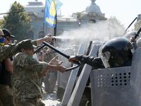 articles/2015/08/31/kiev-grenade-kills-riot-police-as-divided-ukraine-oks-minsk-ceasefire/150831-ukraine-clashes-tease_rmwokk