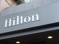 Hilton hotel entrance awning with logo and recessed lights, San Francisco, California, August 19, 2025.