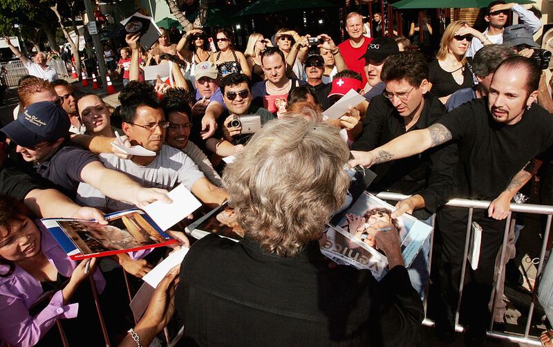 Actor Kris Kristofferson signs autographs at the premiere of DreamWork's “Dreamer” in Los Angeles, California.