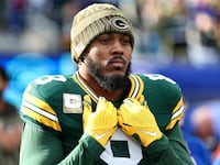 EAST RUTHERFORD, NEW JERSEY - NOVEMBER 16: Josh Jacobs #8 of the Green Bay Packers stands on the sidelines during the national anthem prior to an NFL football game against the New York Giants at MetLife Stadium on November 16, 2025 in East Rutherford, New Jersey. (Photo by Kevin Sabitus/Getty Images)