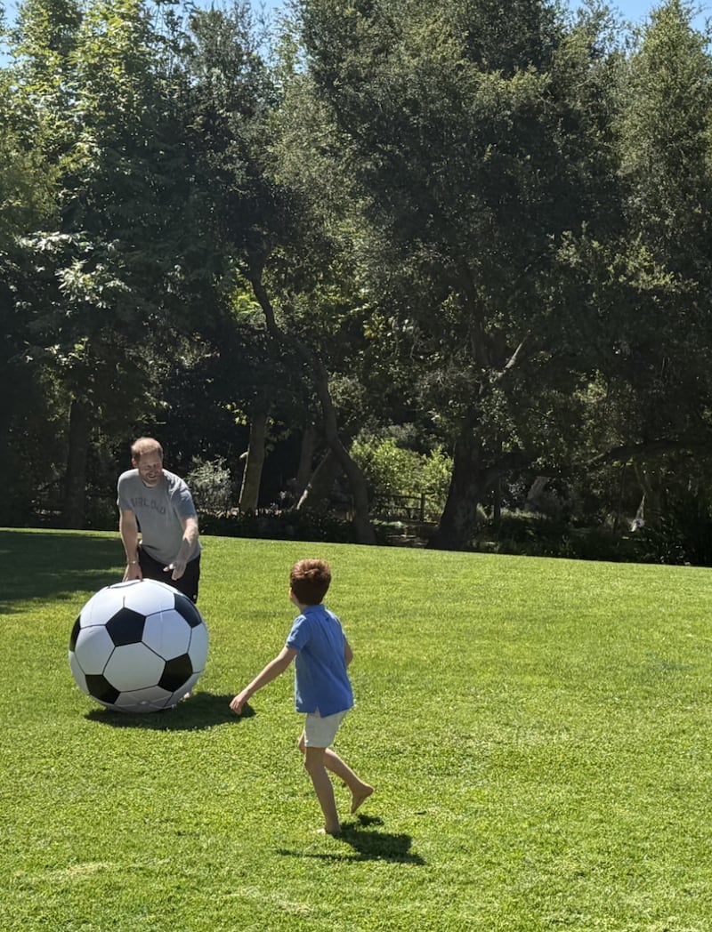 Prince Harry and his son, Prince Andrew, appear in an Instagram post with matching red hair, playing with a soccer ball.