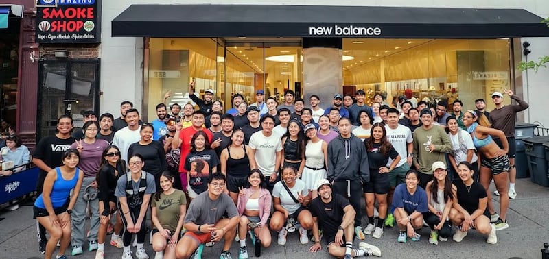 Members of the Paso Run Club pose outside a New Balance store.