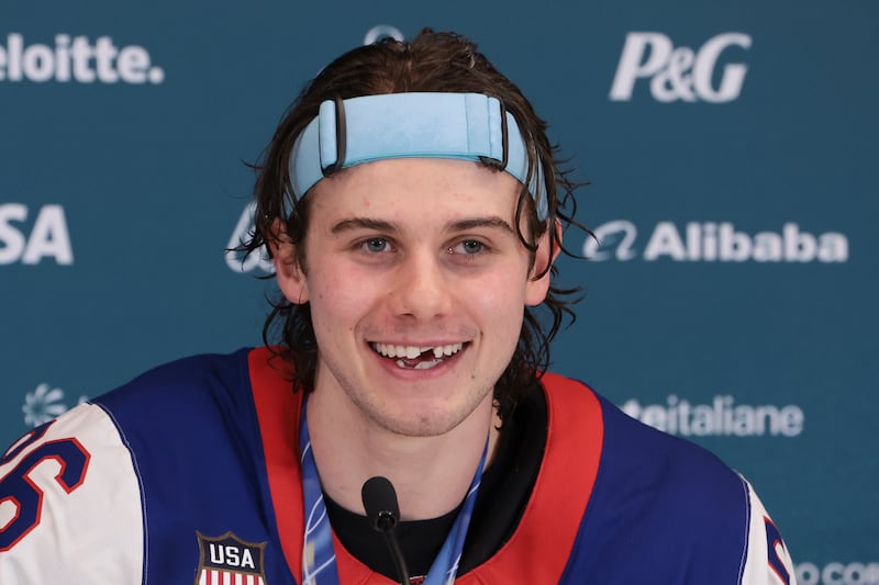 MILAN, ITALY - FEBRUARY 22: Jack Hughes #86 of United States shows his broken teeth during a press conference following the Ice Hockey Men Final between United States and Canada on day sixteen of the Milano Cortina 2026 Winter Olympic Games at Milano Santagiulia Ice Hockey Arena on February 22, 2026 in Milan, Italy. (Photo by Jean Catuffe/Getty Images)
