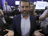 Donald Trump Jr. speaks to the media in the media filing center as a surrogate on behalf of his father, former U.S. President Donald Trump
