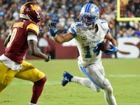 Lions wide receiver Amon-Ra St. Brown (14) runs after a catch during the Detroit Lions versus Washington Commanders National Football League game at Northwest Stadium on November 9, 2025 in Landover, MD.