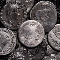 22 September 2026, North Rhine-Westphalia, Bonn: Roman coins, including the oldest coin (M) dating from 148 B.C., when Rome was still a republic without an emperor, are on display at the LVR State Museum. On an ordinary field near Wesseling, south of Cologne, Riedl, a family man, discovered a treasure from Roman times. He was using a metal detector there when he suddenly came across one silver coin after another. Photo: Rolf Vennenbernd/dpa (Photo by Rolf Vennenbernd/picture alliance via Getty Images)
