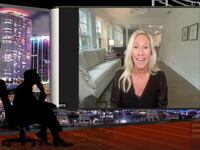 Marjorie Taylor Greene, using a webcam, smiles as she appears on a popular QAnon-show.