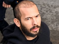 British-US influencer Andrew Tate arrives handcuffed and escorted by police at a courthouse in Bucharest on February 1, 2023.